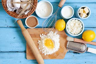 Frame of food ingredients for baking on a blue wooden background, cooking flat lay