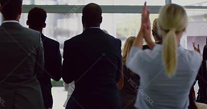 Business people applauding male speaker in a business seminar 4k