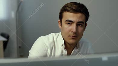 Close-up face portrait of serious focused trader looking at screen stock online