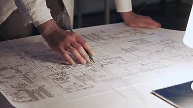 Close up of engineer`s hands making notes on control electronics scheme