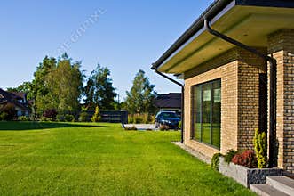 Modern house side yard with large garden window
