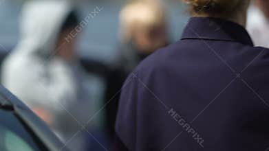 Patrol woman getting out car and approaching car accident witnesses, occupation