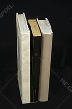Books standing up black background
