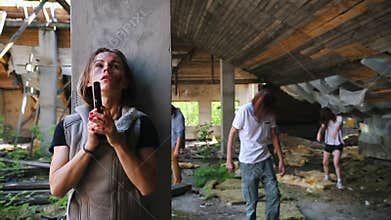 Survived woman with a gun hiding behind a column from zombies in abandoned building