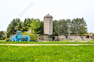 Blue Case Tractor in Front of Destoyed Barn