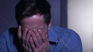 Young man crying desperately, suffering bereavement or life troubles, closeup