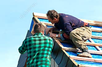 Two roofers at work
