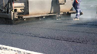 Paver Finisher Placing Layer of Asphalt During Repaving Construction