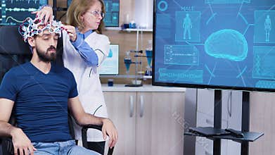 Male patient in modern technology on his head for reading brain activity