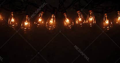 Antique light bulbs flickering and flashing on old dark background