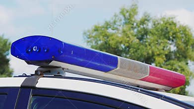 Blinking police flashing lights during the day. Police patrol car