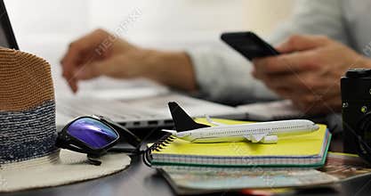 Travel booking - man using laptop for online hotel and flight ticket reservations
