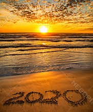 2020 inscription written on sandy beach