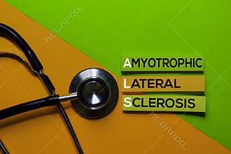 ALS. Amyotrophic Lateral Sclerosis acronym on sticky notes. Office desk background