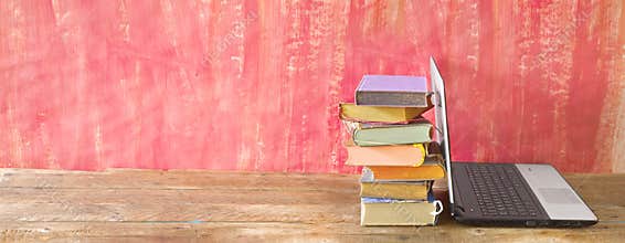 Stack of books and laptop computer, e- learning,learning,reading, education, panorama, copy space