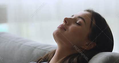 Healthy young woman taking deep breath of fresh air
