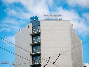 Building with light tiling. At the top is Family doctor paid private clinic network logo and the blue heart and cross symbol