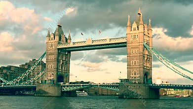 Tower Bridge, London, skyline at sunset with Thames river lights reflected on river, famous London landmark