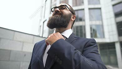 Confident business man adjusting tie, ready for job interview, career promotion