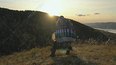 Ritual traditional dance with tambourine Siberian shaman at sunset.
