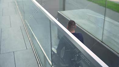 4k resolution follow back view of a man on electric wheelchair using a ramp. Accessibility concept