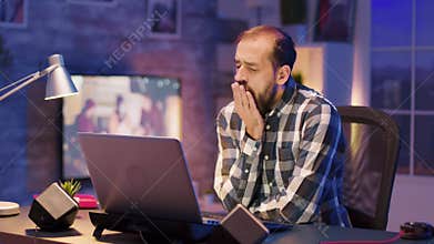 Overworked young freelancer working late night hours from home