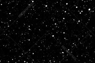 Falling snow on black background. Real blurry snowflakes on black background