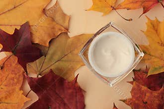 Fall moisturiser flat lay with leaves