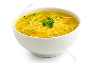 Instant chicken noodle soup in a white ceramic bowl isolated on white. Parsley garnish