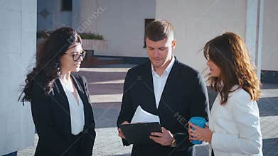 Group of female and male start-up business team celebrating success of project. Business people have fun throwing paper