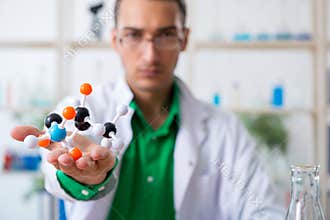 Young male chemist teacher in the lab