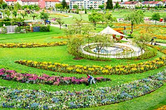 Blooming flowerbeds in Park of Schwabisch-Gmuend, Germany. Urban nature in spring. Flowers in bloom in circled flowerbeds.