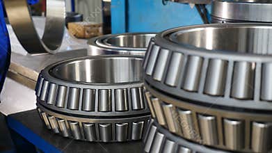 Bearing assembly. Close up. Worker sets part of rolling bearing and turns it. Heavy machinery concept. Part of