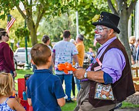 Elderly Balloon Artist Making Balloons for Kids