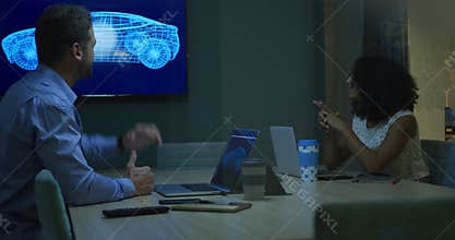 Young office executives discussing over laptop in a modern office