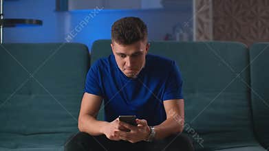 Excited man winner holding using smartphone feeling overjoyed with mobile online bet bid gambling game win, happy guy