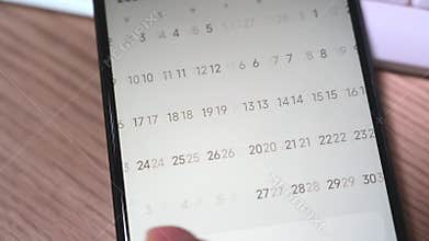 Close-up of a man`s hand using a smartphone calendar application