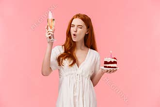 Carefree amused, happy girl having fun on her birthday party, raising glass of champagne, drinking alcohol turn adult