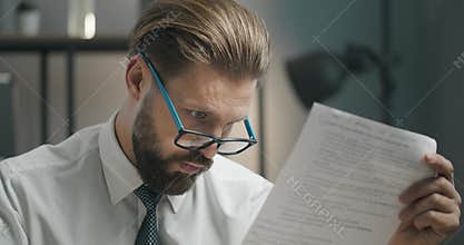 Shocked Businessman Checking Document