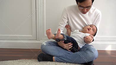 Asian boy crying for attention whlie parents are trying to comfort him