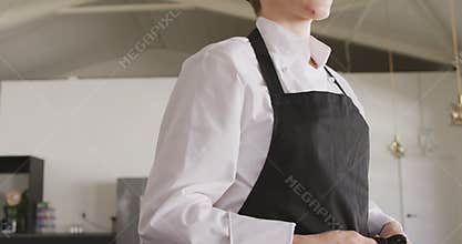 Chef putting on her apron