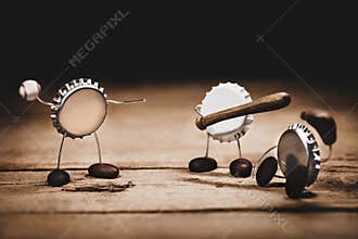 Crown cork or bottle caps miniature figures playing baseball, concept beverage and sport events