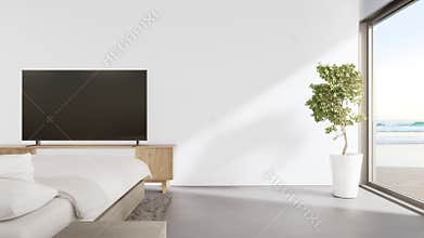 Sea view bedroom of luxury summer beach house with television on TV stand near bed.