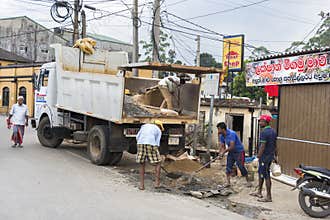 Nuwara Eliya, Sri Lanka: 03/20/2019: Workers loading a truck with building materials