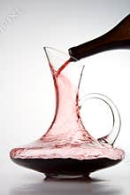 Pouring red wine into decanter