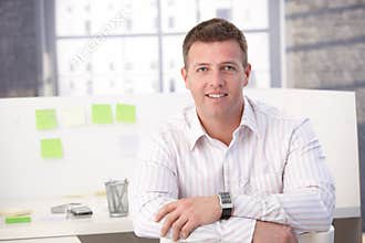 Casual office worker smiling in office