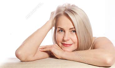 Portrait of cheerful senior woman smiling while looking away at spa. Happy mature woman after spa massage and anti-aging treatment