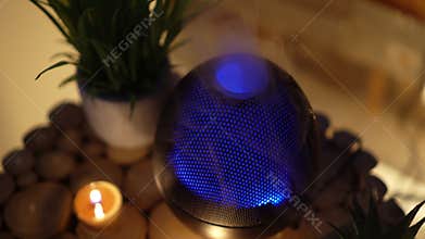 Aroma electric oil diffuser lamp, candles on wooden table in room. Aromatherapy, 4k