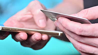 Financial transactions. Online. Pay with a credit card via phone. The girl uses a bank card and a phone.