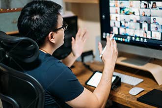 Young asian business man using computer for a online business meeting with his colleagues about plan in video conference. back